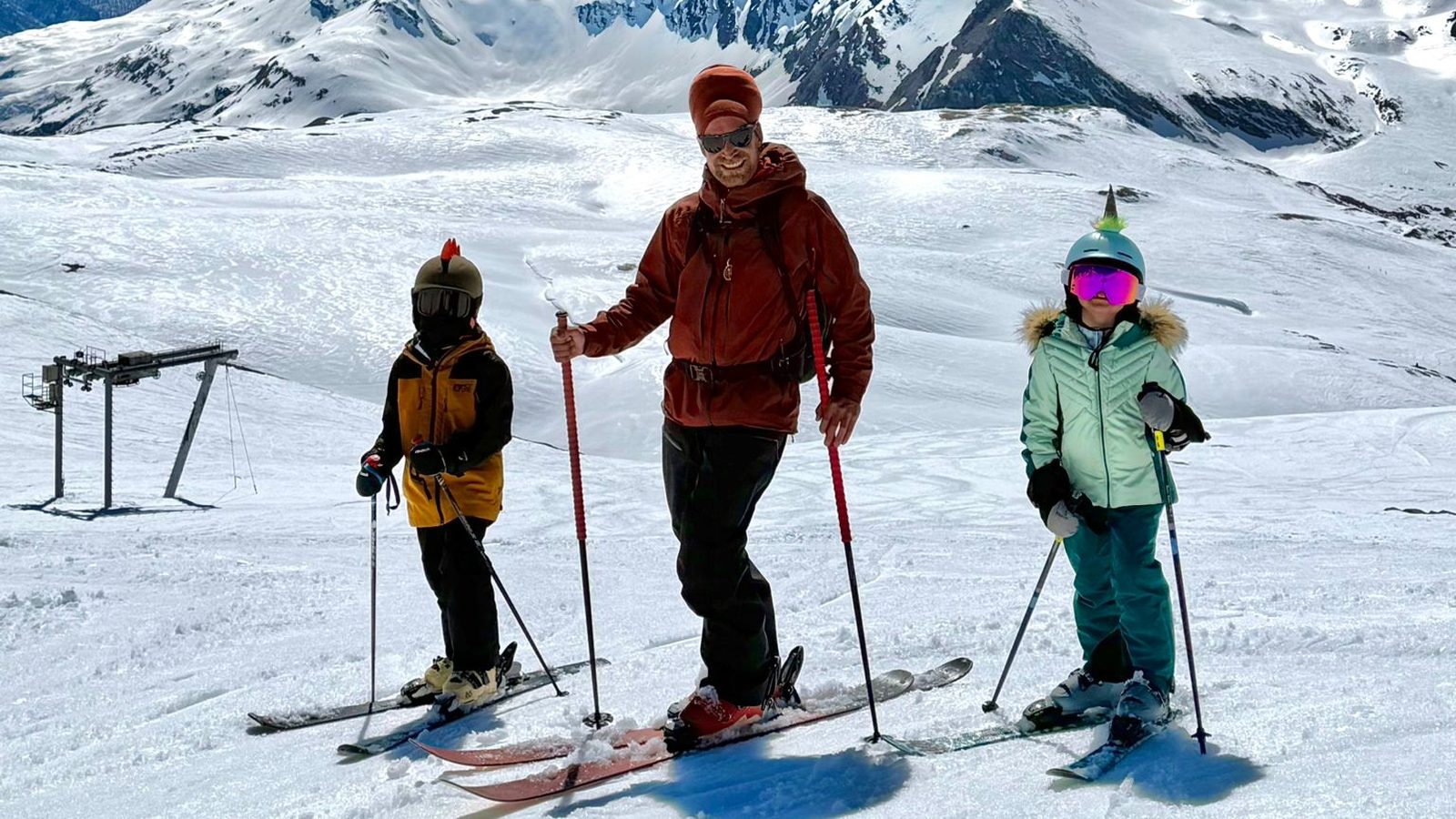 Ski instructor with two children during a private ski lesson in the mountains